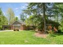 Beautiful brick home with a well-manicured lawn and mature trees, offers great curb appeal and charm at 7420 Denton Cir, Indianapolis, IN 46256