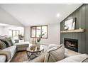 Inviting living room with a fireplace, large windows, and comfortable seating at 7665 Stones River Ct, Indianapolis, IN 46259
