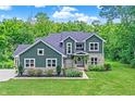 Charming two-story home with a well-manicured lawn, stone accents, and inviting curb appeal at 7716 Traders Hollow Ln, Indianapolis, IN 46278