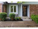 Charming front porch with room for seating, enhanced by manicured landscaping and stylish brick accents at 780 Wilson Terrace Ct, Carmel, IN 46032