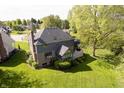 Aerial view of backyard showing deck, enclosed porch, and a sprawling lawn at 839 Pebble Brook Pl, Noblesville, IN 46062