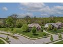 An aerial view showcases this property's location and landscaped yard in a lush, green neighborhood at 10504 Ruxton Ct, Fishers, IN 46040