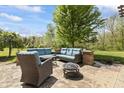 Cozy backyard patio with comfortable outdoor seating and a fire pit, perfect for relaxation at 10504 Ruxton Ct, Fishers, IN 46040