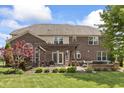 Brick backyard featuring a pergola-covered patio with outdoor seating, ideal for entertaining or relaxation at 10504 Ruxton Ct, Fishers, IN 46040