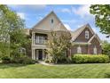 Charming two-story brick home featuring a welcoming front porch and beautifully manicured lawn at 10504 Ruxton Ct, Fishers, IN 46040