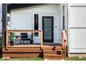 Inviting front porch with stylish furniture and wood railing, perfect for relaxing at 1112 Spann Ave, Indianapolis, IN 46203