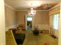 Spacious living room with vintage wallpaper, chandelier, and natural light at 1207 Van Buskirk Rd, Anderson, IN 46011