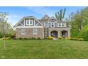 Charming two-story home with a stone facade, covered entryway, and lush green lawn at 12811 Corydon Dr, Fishers, IN 46037
