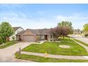Beautiful single-story home with a brick facade, lush green lawn, and a convenient two-car garage at 1283 Easton Point Dr, Greenwood, IN 46142