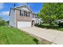 Lovely two-story home featuring attached two-car garage, brick accents, and a well-maintained lawn at 1966 Freedom Ct, Greenfield, IN 46140