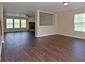 Spacious living room featuring hardwood floors, a fireplace, and abundant natural light through large windows at 1966 Freedom Ct, Greenfield, IN 46140