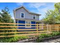 Charming two-story home with a blue-and-gray exterior, complemented by a well-maintained yard and wood fence at 213 S State Ave, Indianapolis, IN 46201