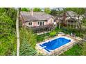 Stunning backyard featuring a sparkling in-ground pool, spacious patio, and beautifully landscaped greenery at 265 Monticello Dr, Greenwood, IN 46142