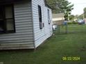 Side view of home with a spacious, grassy backyard, with a chain link fence at 3057 S Rybolt Ave, Indianapolis, IN 46241