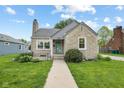 Charming stone-clad home featuring a quaint front entrance and well-maintained landscaping at 311 Duffey St, Plainfield, IN 46168