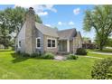 Lovely home featuring stone and siding, a well-manicured lawn, and mature trees at 311 Duffey St, Plainfield, IN 46168