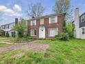 Classic brick two-story home, showcasing symmetrical design, white-trimmed windows, and a front entrance at 3516 Janet Dr, Indianapolis, IN 46218