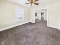 Neutral toned living room features plush carpet and natural light through a large window at 510 E 23Rd St, Anderson, IN 46016