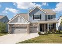 Charming two-story home with blue siding, brick accents, and a spacious two-car garage at 5770 Flagler Ln, Brownsburg, IN 46112