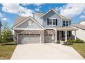 Charming two-story home with blue siding, brick accents, and a spacious two-car garage at 5770 Flagler Ln, Brownsburg, IN 46112