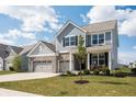 Charming two-story home with blue siding, brick accents, and a spacious two-car garage at 5770 Flagler Ln, Brownsburg, IN 46112