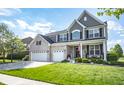 Charming two-story home with manicured lawn, three car garage and welcoming front porch at 6064 Bartley Dr, Noblesville, IN 46062