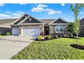 Charming single Gathering home with a well-manicured lawn and a three car garage at 6153 Dugan Dr, Whitestown, IN 46075