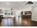 Spacious living room with fireplace flows into modern kitchen, perfect for entertaining at 6153 Dugan Dr, Whitestown, IN 46075