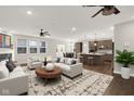 Open-concept living room showcasing modern decor and seamless flow into the kitchen and dining areas at 6153 Dugan Dr, Whitestown, IN 46075