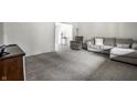 Spacious living room with neutral carpet, ample seating, and natural light at 6938 Rio Grande Dr, Indianapolis, IN 46217