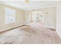 Cozy living room with neutral walls, arched doorways, and view of the kitchen at 717 E 27Th St, Anderson, IN 46016