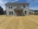 Grey two-story home with a covered porch on a lot with newly sown grass at 7509 Big Bend Blvd, Camby, IN 46113