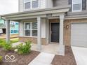 Inviting front porch with classic columns and stone accents on a two-story home at 7509 Big Bend Blvd, Camby, IN 46113