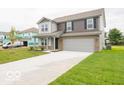 Charming two-story home with a well-manicured lawn and attached two-car garage at 7509 Big Bend Blvd, Camby, IN 46113
