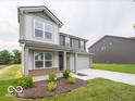Two-story home featuring stone accents, attached two-car garage, and fresh landscaping at 7509 Big Bend Blvd, Camby, IN 46113