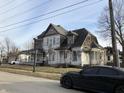 Two story home with covered porch and peeling paint needing repairs at 802 S Anderson St, Elwood, IN 46036