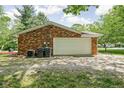 A detached garage showing the exterior brick finish, and utility access at 818 Merry Ln, Greenwood, IN 46142
