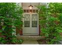 Close-up of the home's front entry showing double doors framed by lush greenery and hanging lantern at 8227 Hoover Ln, Indianapolis, IN 46260