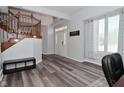 Bright foyer with wood staircase, grey floors and large window for natural light at 8627 Lansdowne Dr, Fishers, IN 46038