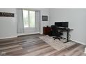 Office area has grey floors, decor, a large window for natural light, and desk at 8627 Lansdowne Dr, Fishers, IN 46038