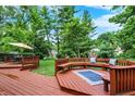 Multi-tiered deck featuring outdoor lounge area and dining with lush green surroundings at 9036 Buckeye Ct, Indianapolis, IN 46260