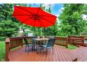 Outdoor dining on a spacious deck with a red umbrella, perfect for summer evenings at 9036 Buckeye Ct, Indianapolis, IN 46260