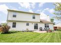 Spacious backyard with a patio, lush lawn, and well-maintained exterior of the two-story home at 905 N Main St, Fortville, IN 46040