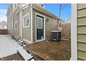 View of the back entrance and an AC unit on a concrete pad, highlighting practical aspects of the property at 923 S State Ave, Indianapolis, IN 46203