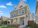 Attractive home with a covered front porch, showcasing its architectural style and curb appeal at 923 S State Ave, Indianapolis, IN 46203