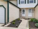 Charming front entrance with well manicured landscaping and solar powered accent lighting at 9493 Timber View Dr, Indianapolis, IN 46250