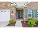 Welcoming front entrance with brick facade, manicured landscaping, and a well-lit doorway at 9823 Pica Dr, Fishers, IN 46040