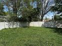 Large fenced backyard with a neatly mowed green lawn and bright sunlight at 9976 W Center St, Anderson, IN 46011