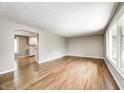 Open floor plan with hardwood floors connecting the living area to the adjacent kitchen at 101 N Westbury Rd, Pendleton, IN 46064
