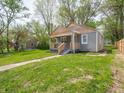 Angle view of home with manicured lawn and tidy landscaping at 1132 Sharon Ave, Indianapolis, IN 46222